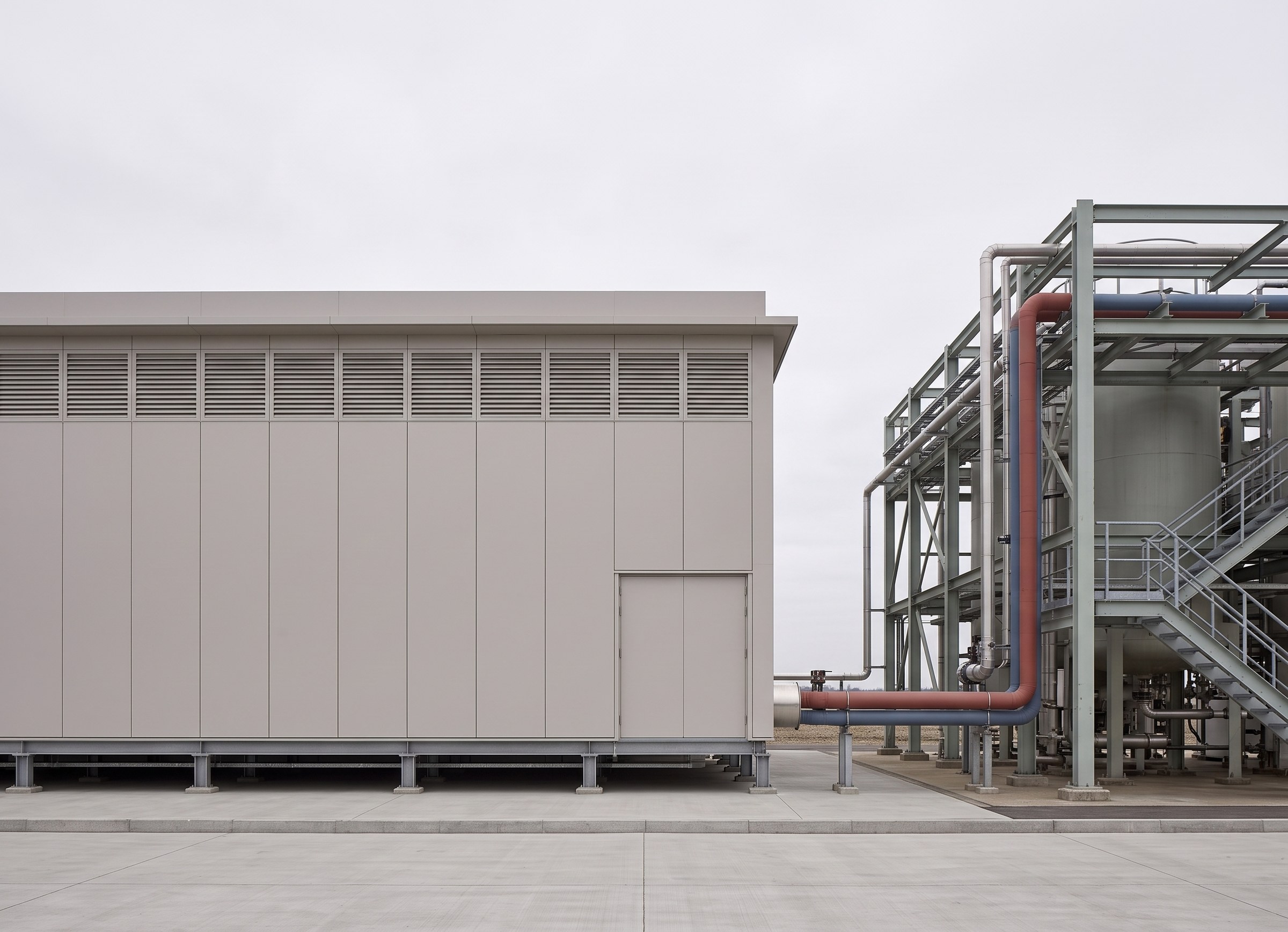 The compute building beside the heat plant, joined by the warm and return pipes